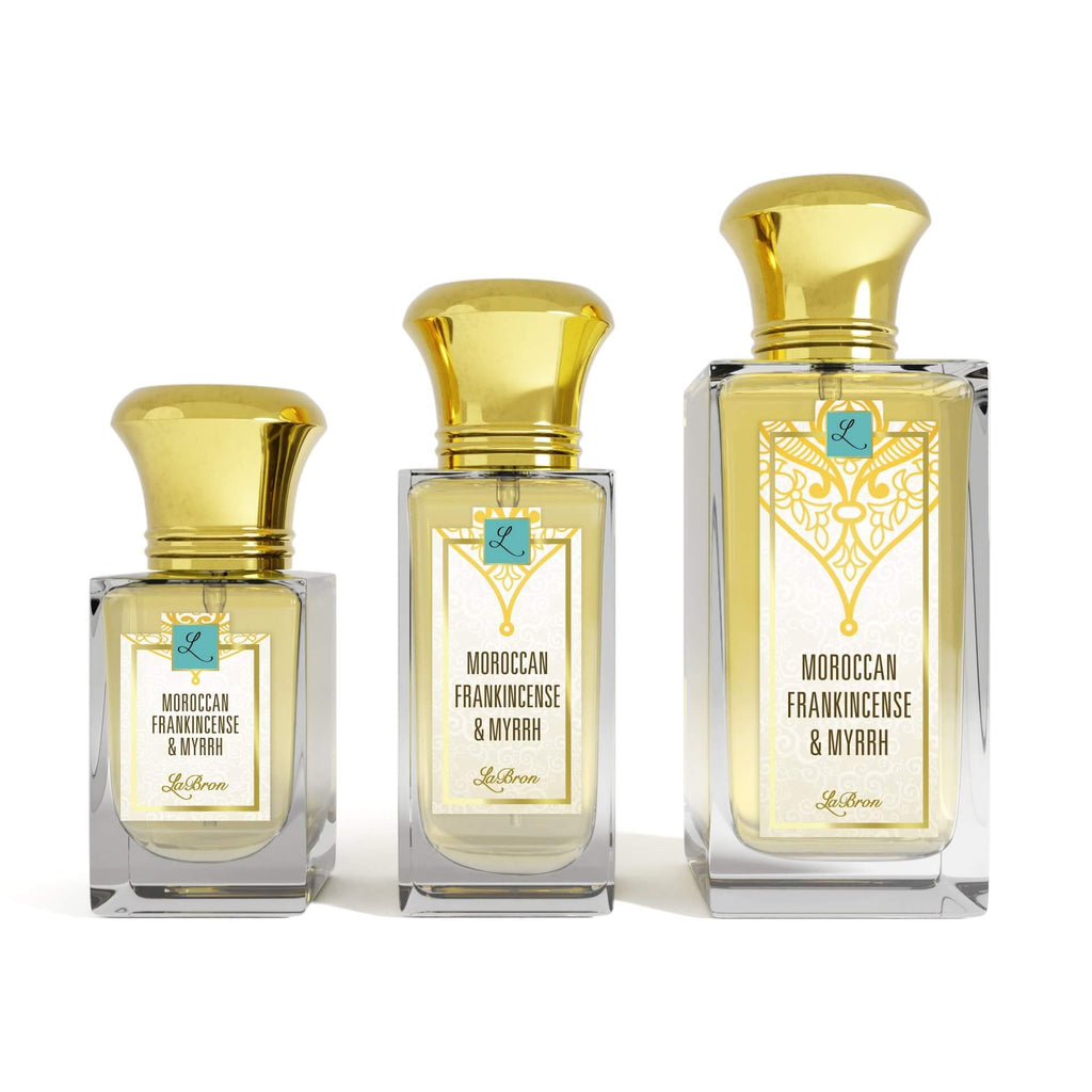 Three sizes of the Moroccan Frankincense & Myrrh perfume laid out in a line with a white background. The label shows a a gold moroccan style with a white background with "Labron" on their label.