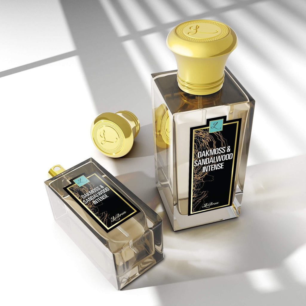 Three sizes of the Oakmoss & Sandalwood laid out in a triangle formation with the camera shot in a higher angle to show the shadows of the products. The label shows black and gold lining with a white background with "Labron" on their label.