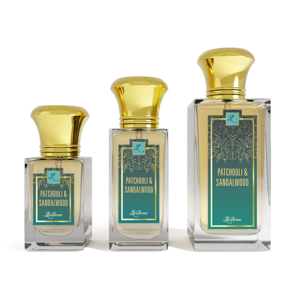 Three bottles of the Patchouli & Sandalwood products shown that are 1.0 - 3.4 oz lined up from smallest to biggest. Their label captivates a blue hue with moroccan themed white lining. The background is white.