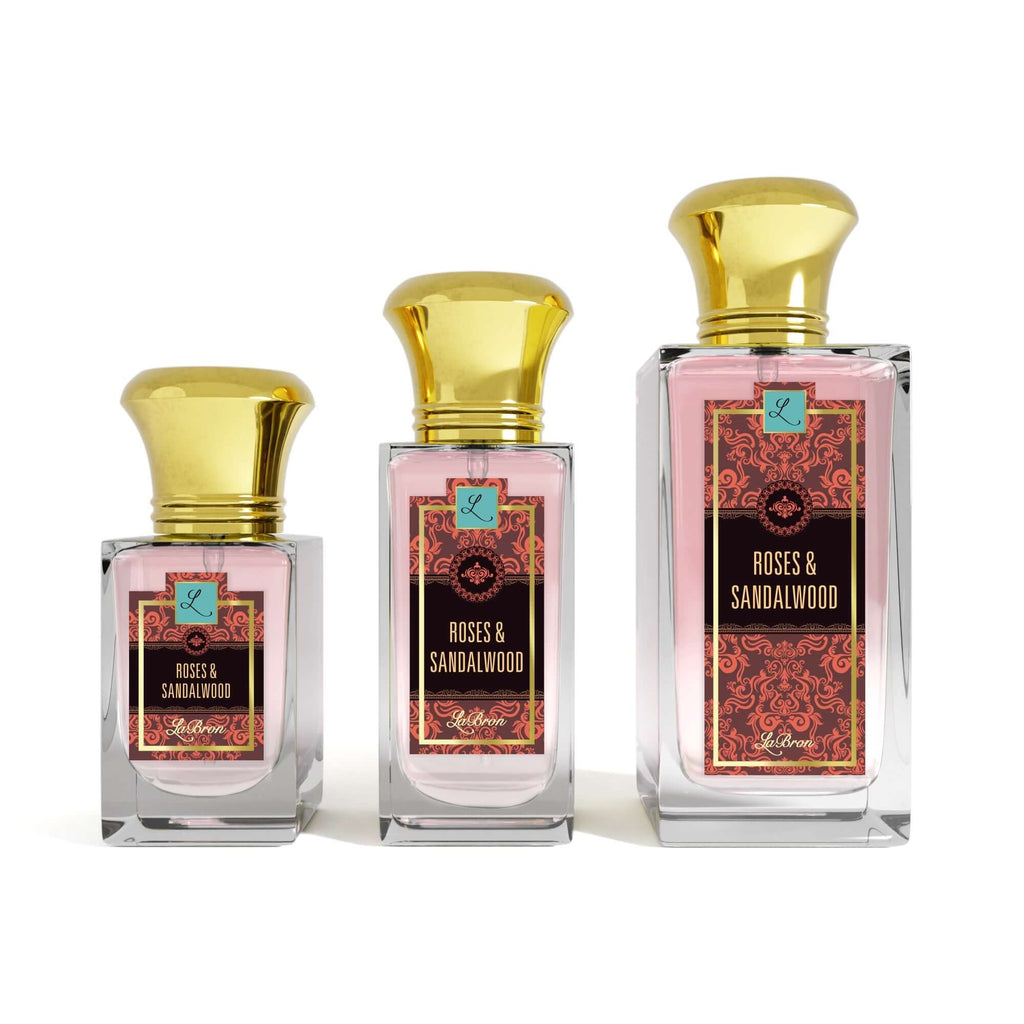 Three bottles of the Roses & Sandalwood products shown that are 1.0 - 3.4 oz lined up from smallest to biggest. Their label captivates a red moroccan style and gold lettering. The background is white.