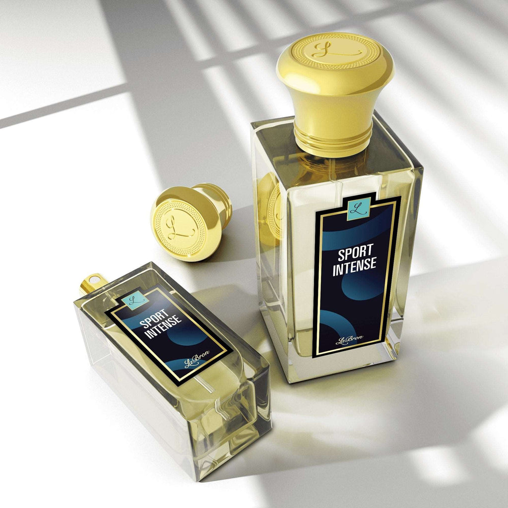 LaBron Sport Cologne Intense for Men two bottles are 1.7 & 3.4 oz lined up from smallest to biggest. The background is white and shot from a higher angle that showcases the shadows of the product and the gold cap they come in.