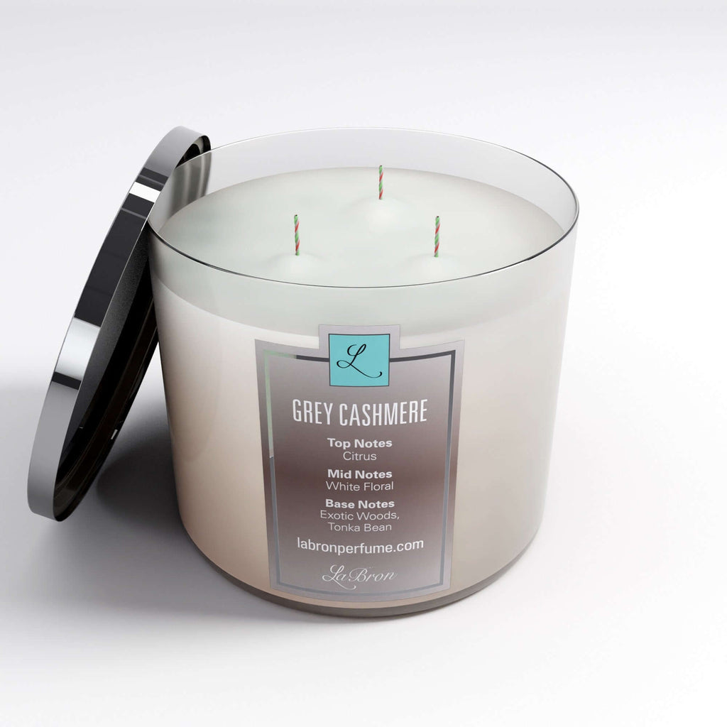 Grey Cashmere candle with the lid off the product. highly scented with citrus as their top note, white floral with their mid note and finished off with an exotic woods, tonka bean base note. 